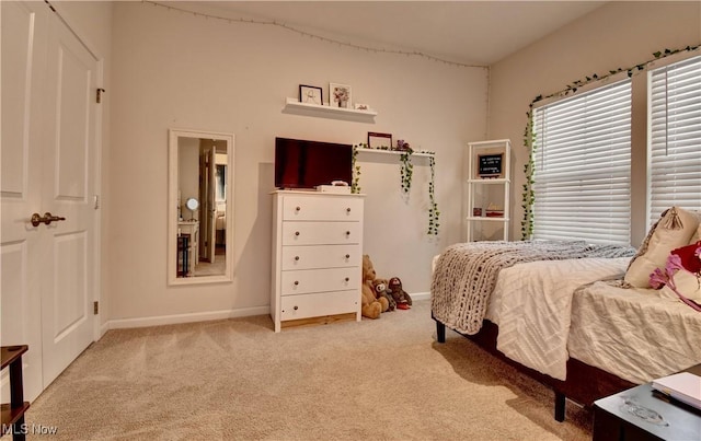 bedroom featuring carpet flooring and baseboards