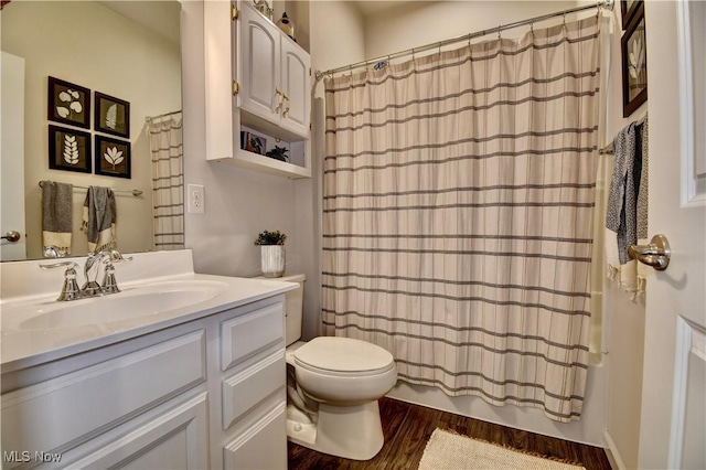 full bathroom with shower / tub combo with curtain, toilet, vanity, and wood finished floors