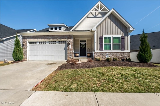 view of front of home featuring board and batten siding, a front lawn, driveway, stone siding, and an attached garage