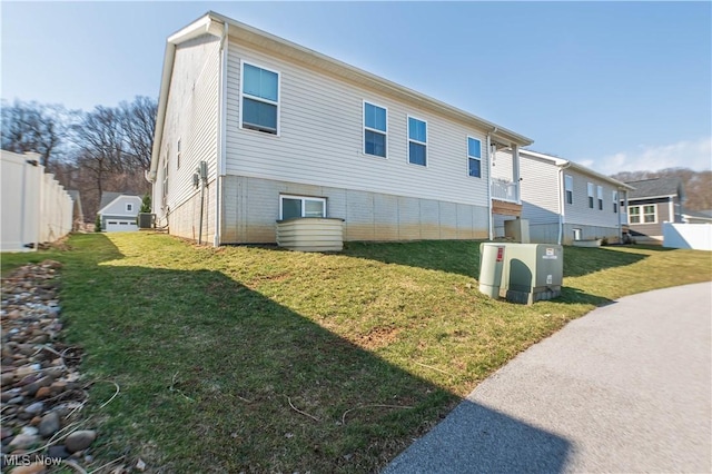 exterior space with a residential view, a lawn, and fence