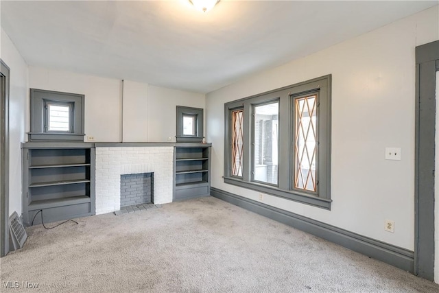 unfurnished living room featuring carpet and a fireplace