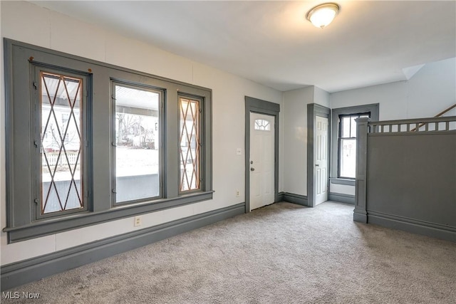 carpeted entryway with baseboards