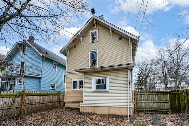 rear view of property with fence