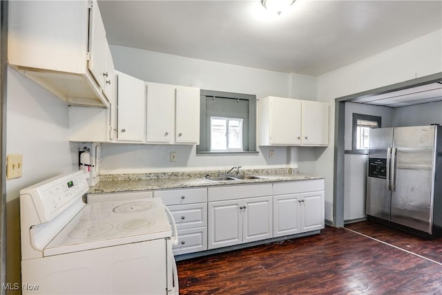 kitchen featuring dark wood-style flooring, a sink, white cabinets, stainless steel fridge with ice dispenser, and white range with electric cooktop