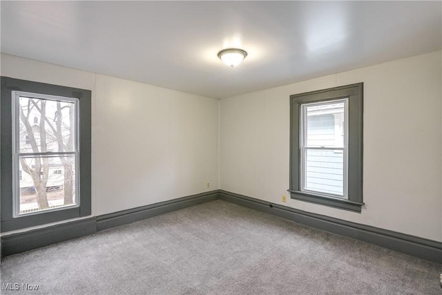 carpeted empty room with plenty of natural light