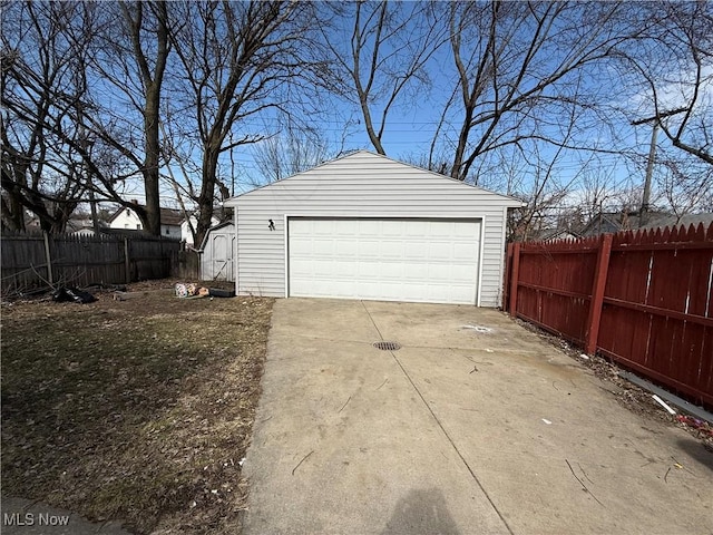 detached garage featuring fence