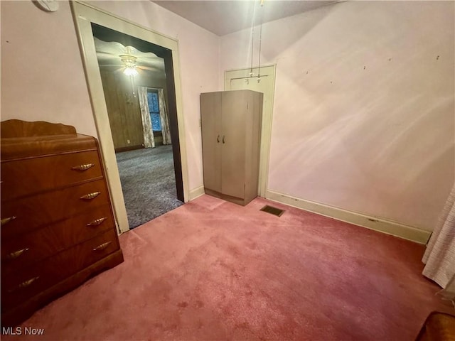 carpeted empty room with baseboards and visible vents