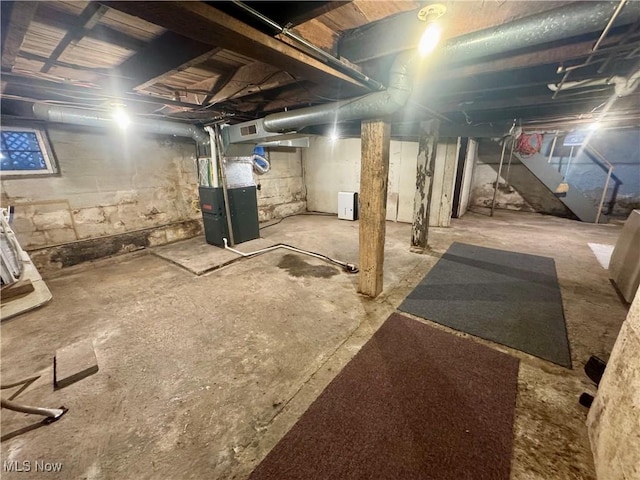 unfinished basement with heating unit and visible vents