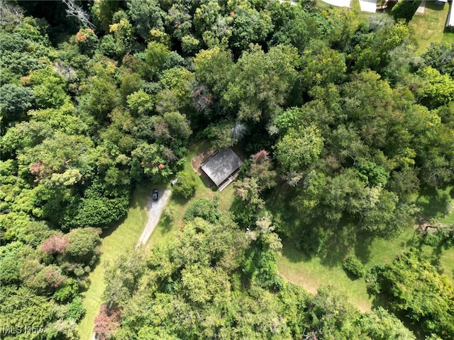 drone / aerial view featuring a forest view