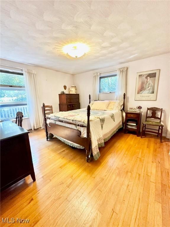 bedroom featuring a textured ceiling and light wood-style flooring