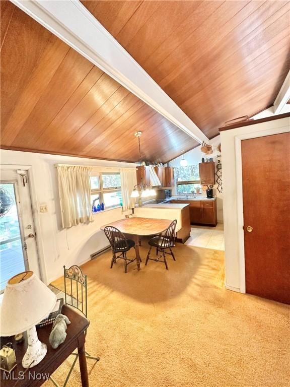 dining space with light carpet, vaulted ceiling, and wooden ceiling