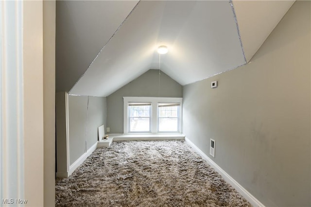 bonus room with lofted ceiling, carpet floors, visible vents, and baseboards