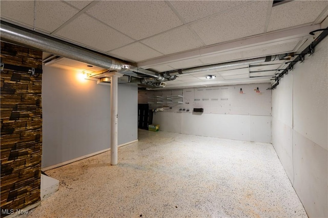 finished basement featuring a drop ceiling