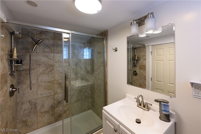 bathroom featuring a stall shower, visible vents, and vanity