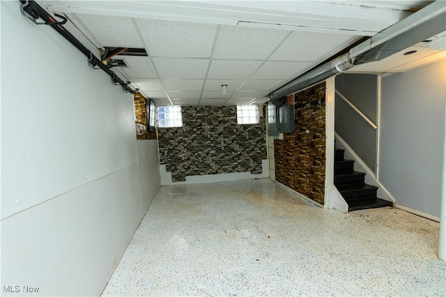 below grade area with stairs and a drop ceiling