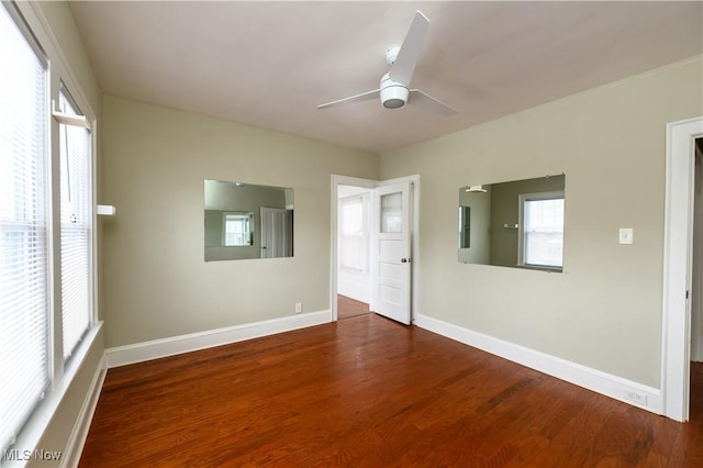 unfurnished room with a ceiling fan, baseboards, and wood finished floors