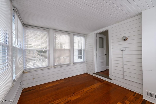 unfurnished sunroom with a healthy amount of sunlight and visible vents