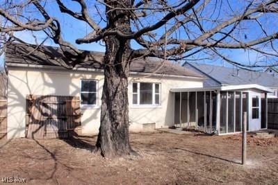 back of house featuring a sunroom