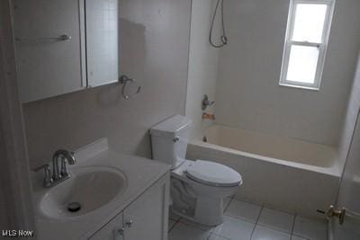 bathroom featuring toilet, tile patterned flooring, vanity, and bathing tub / shower combination