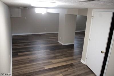 empty room featuring baseboards and wood finished floors