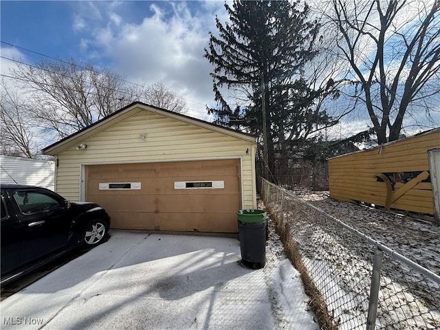 detached garage featuring fence