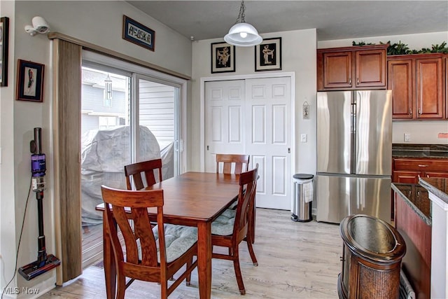 dining space featuring light wood-type flooring