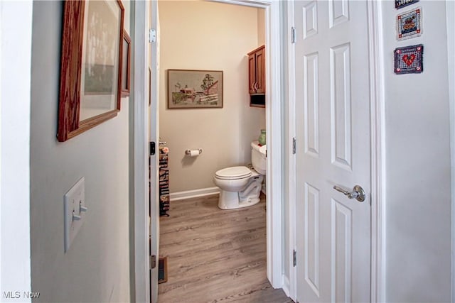 bathroom featuring baseboards, visible vents, toilet, and wood finished floors