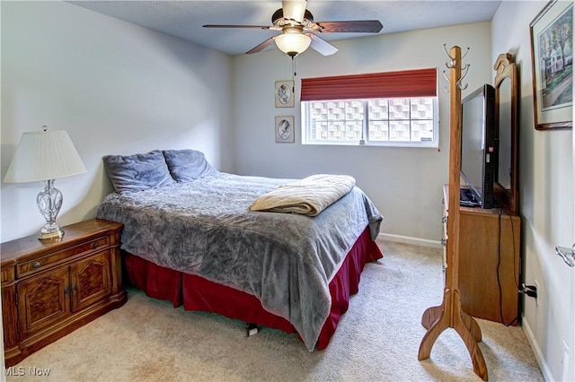 carpeted bedroom featuring ceiling fan and baseboards