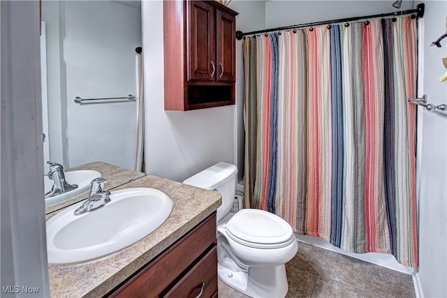 bathroom featuring toilet, a shower with curtain, vanity, and tile patterned floors