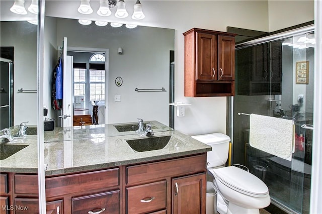 bathroom with toilet, a stall shower, ensuite bath, and vanity