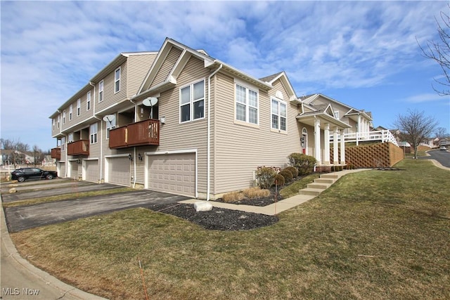 view of home's exterior featuring a garage, driveway, and a yard