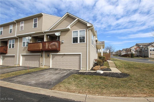 multi unit property featuring a garage, a residential view, and driveway