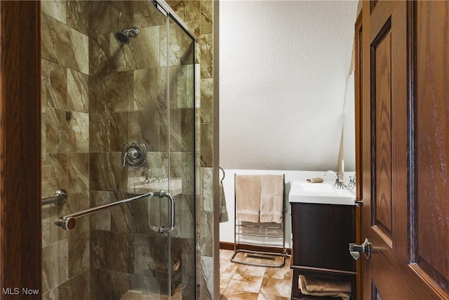 bathroom with a stall shower and vanity