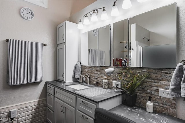 full bathroom featuring vanity and decorative backsplash