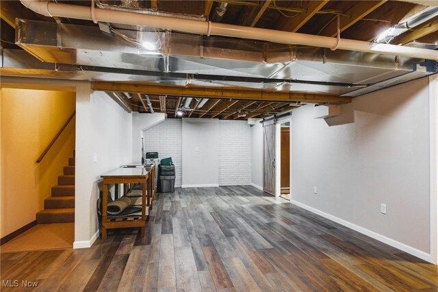 finished below grade area with stairs, wood finished floors, and baseboards