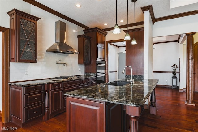 kitchen with dark wood-type flooring, a sink, wall chimney range hood, appliances with stainless steel finishes, and crown molding