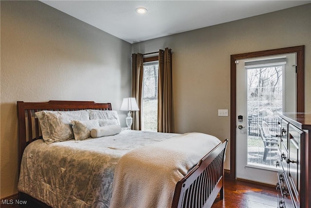 bedroom featuring baseboards and wood finished floors