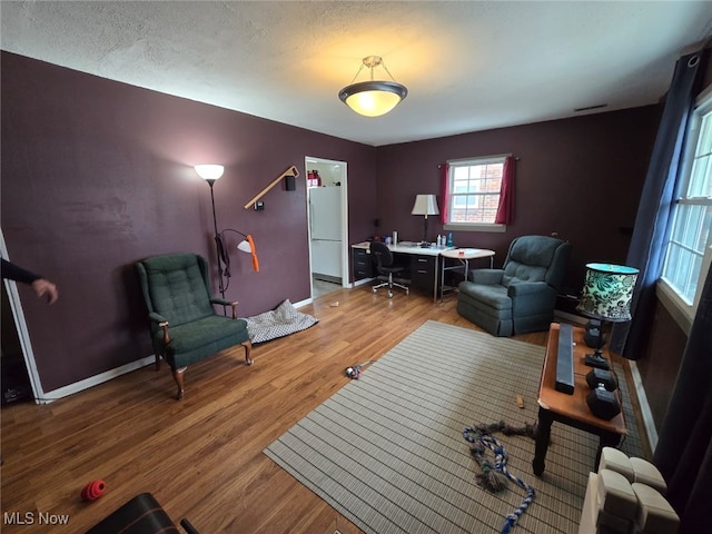 interior space featuring visible vents, baseboards, and wood finished floors