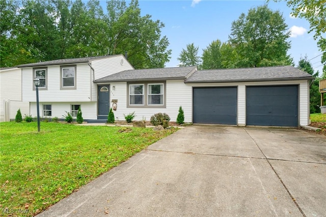 split level home featuring driveway, a front lawn, and an attached garage