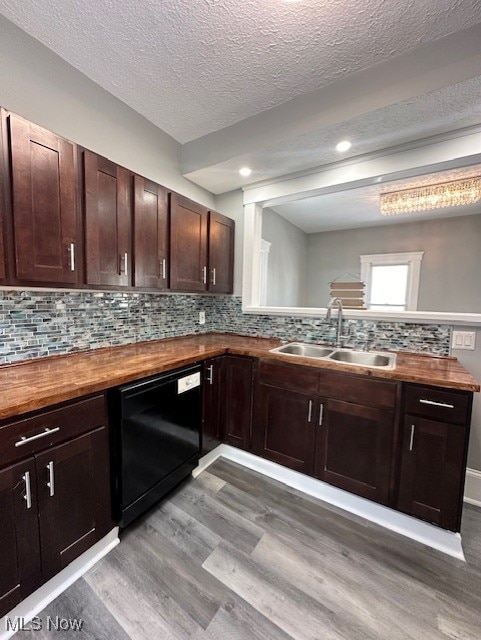 kitchen featuring black dishwasher, dark wood finished floors, wooden counters, and a sink