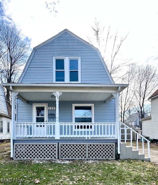 exterior space featuring covered porch and a gambrel roof