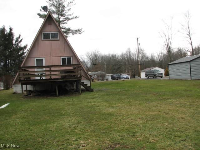 view of yard with a deck and an outbuilding