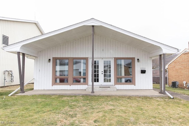 back of house featuring a yard, french doors, and cooling unit