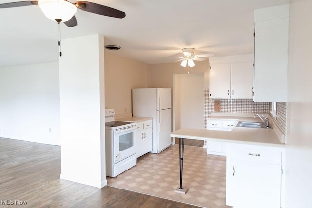 kitchen featuring white appliances, a sink, visible vents, light countertops, and light floors