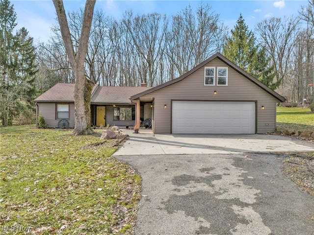 view of front of house featuring an attached garage, driveway, a chimney, and a front lawn