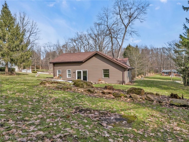 view of home's exterior with a yard and fence