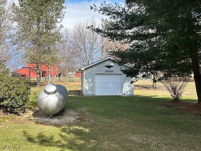 view of yard with an outdoor structure and a detached garage