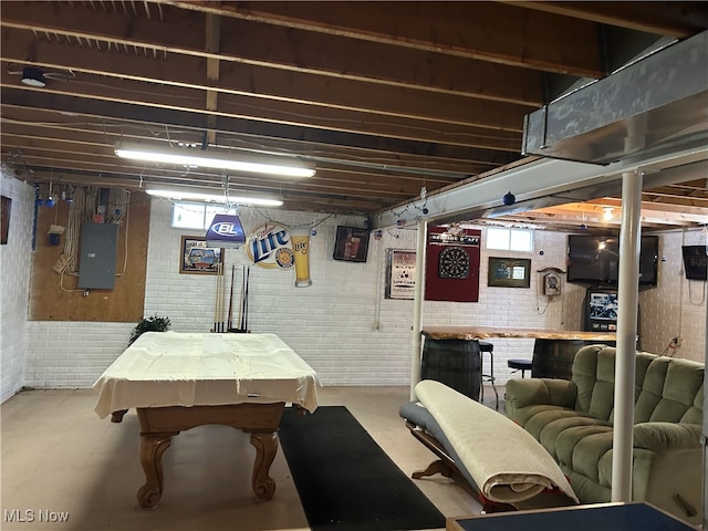 recreation room featuring concrete flooring, pool table, a healthy amount of sunlight, and electric panel