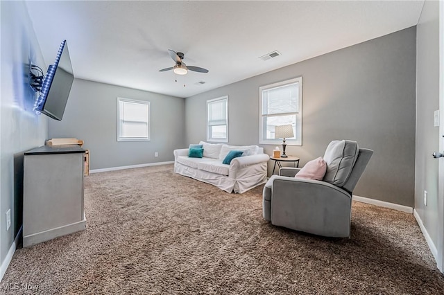 carpeted living area with ceiling fan, visible vents, and baseboards