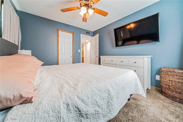 bedroom featuring ceiling fan, visible vents, baseboards, and carpet flooring